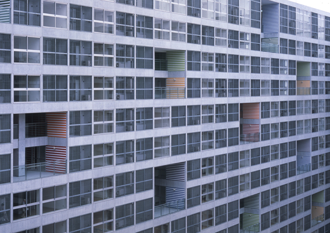 東雲 Canal Court CODAN 1 街區的外皮近景，混凝土棋盤格框架上挖出兩層樓高的共用露台
